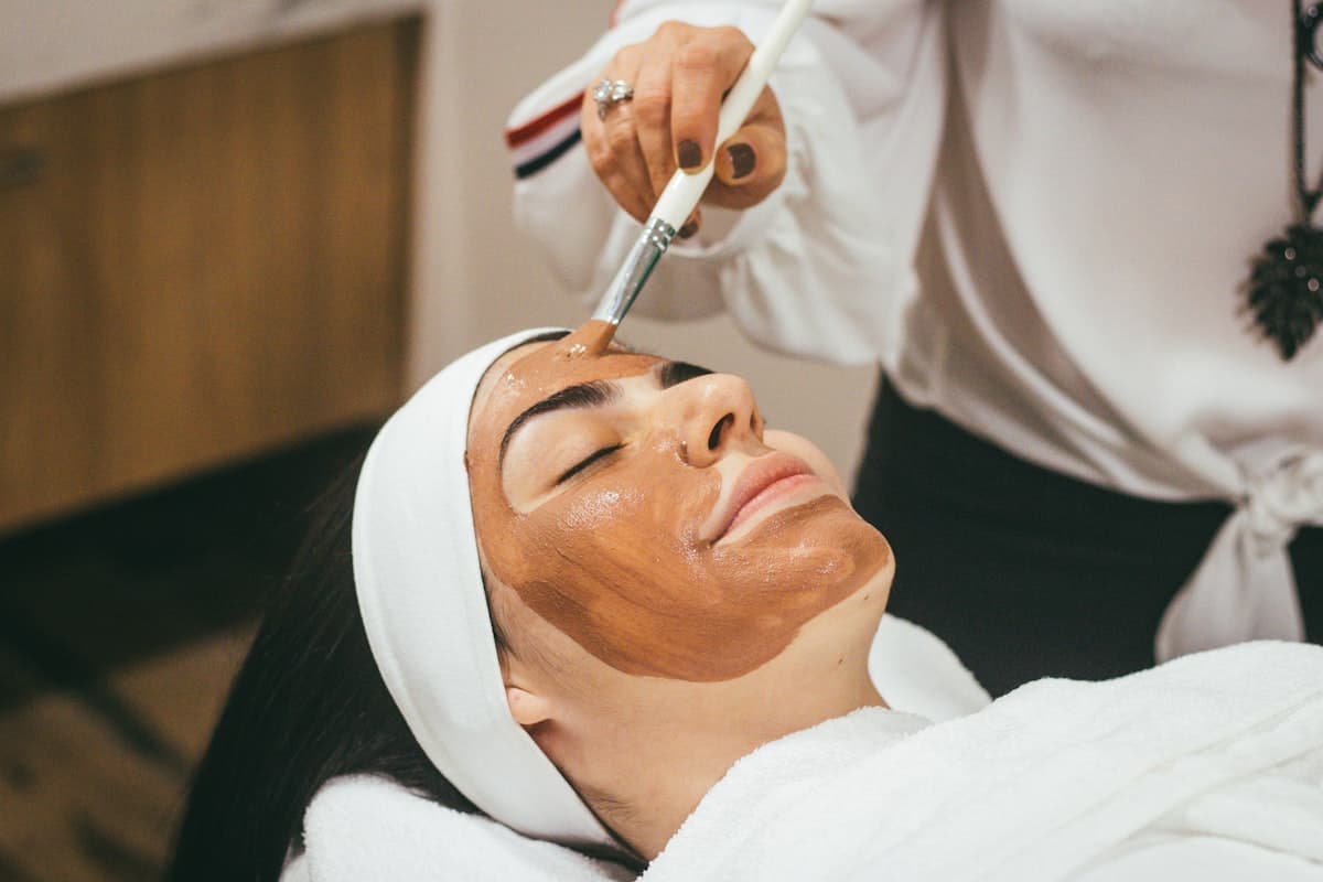 Serene aesthetic care setting with soft towels and light